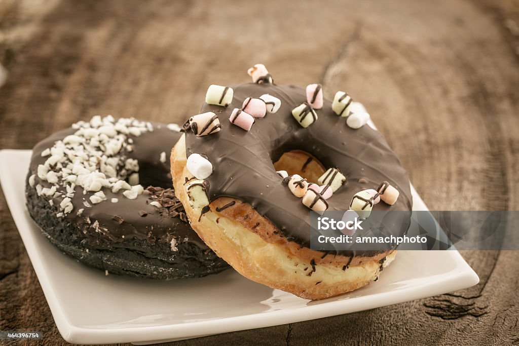 Chocolate donut with Sprinkles . Chocolate donut with Sprinkles on white plate. Chocolate Doughnut Stock Photo