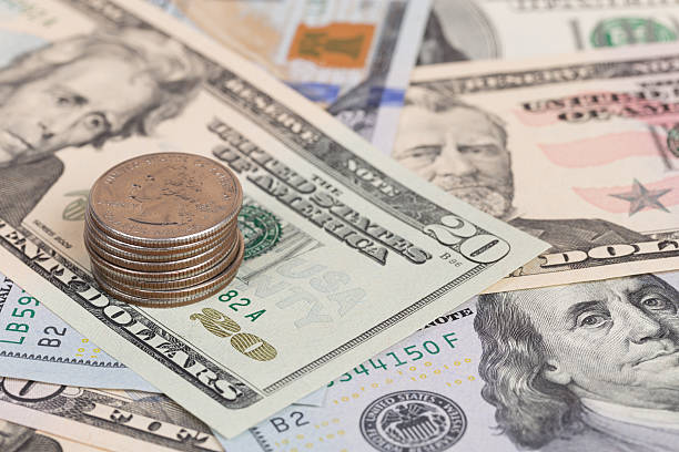 istock US coins on US banknotes close up 464397104