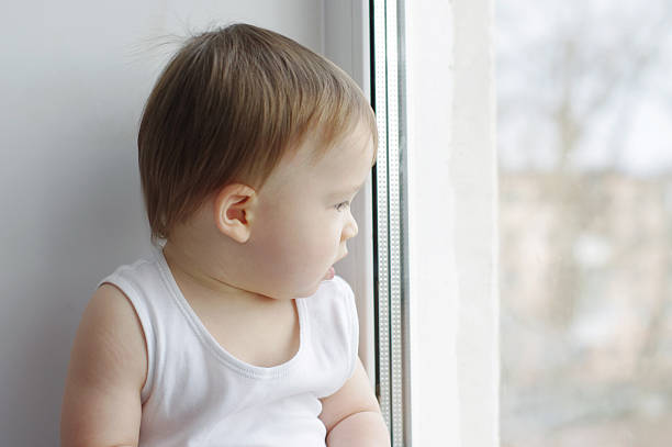 istock baby looks out of window 464397929