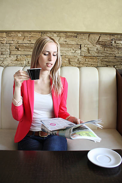 istock Pretty blonde reading the newspaper and  drinking coffee 464400636