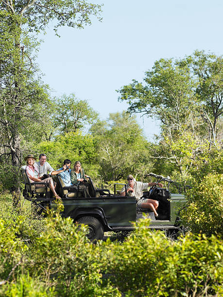 istock Tourists And Driver In Jeep On Safari 464400770