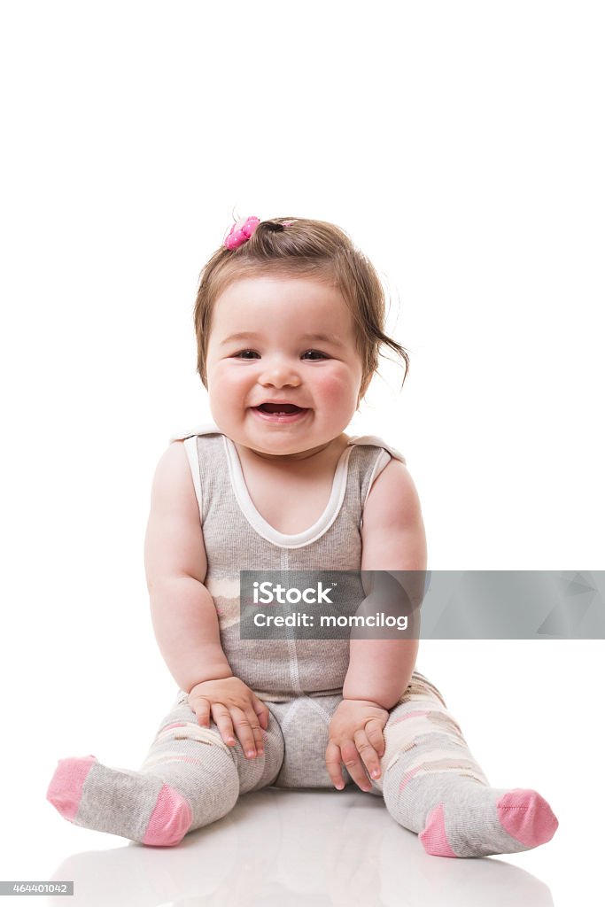 Adorable baby girl Happy and adorable baby girl sitting and smiling, isolated on white 12-17 Months Stock Photo