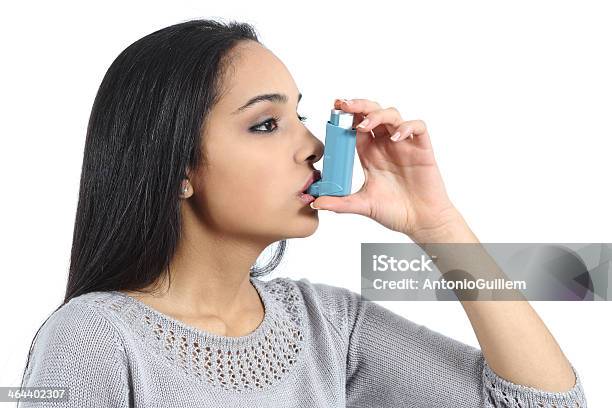 Asthmatic Arab Woman Breathing From A Inhaler Stock Photo - Download Image Now - Asthma Inhaler, Asthmatic, Islam