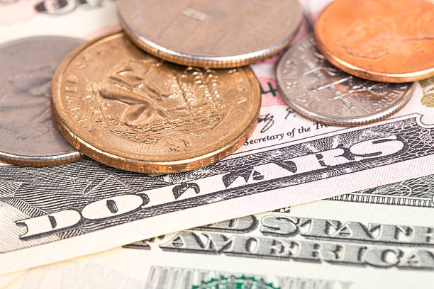 istock US coins on US banknotes close up 464402634