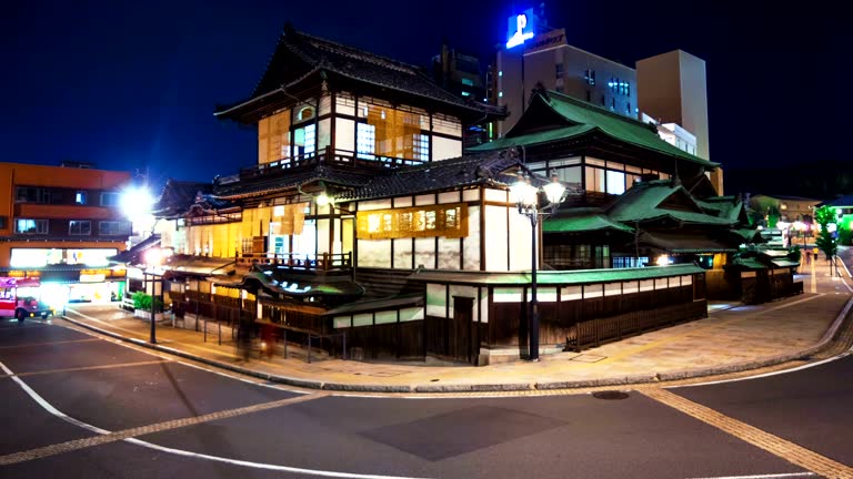 Time lapse of the ancient Japanese bathhouse surrounded by car and foot traffic.