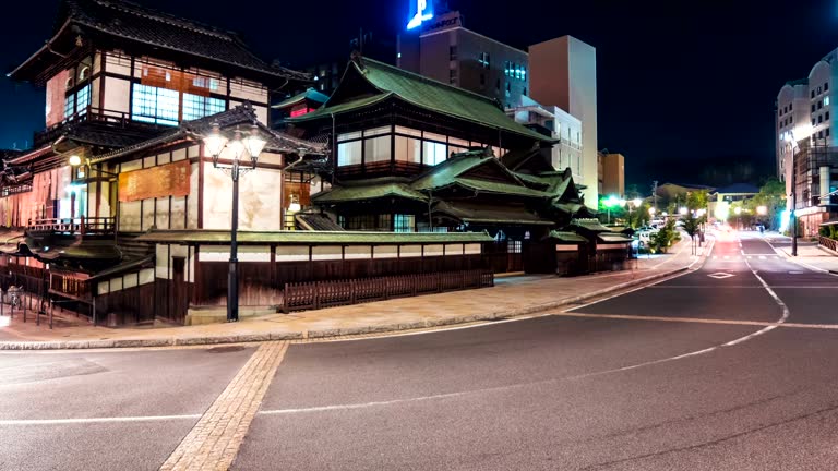 Time lapse of the ancient Japanese bathhouse surrounded by car and foot traffic.