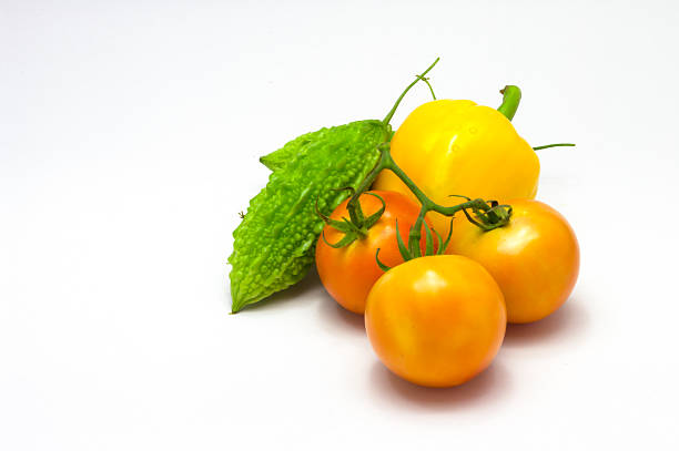 istock tomatoes,bitter gourd  & Chili pepper isolated on white backgrou 464405348
