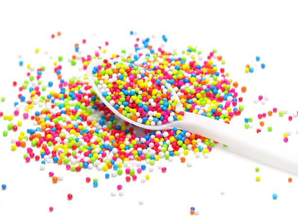 istock colorful sugar pearls in white spoon 464405484