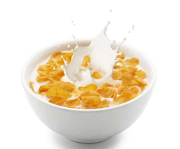 corn flakes with milk splash isolated on white