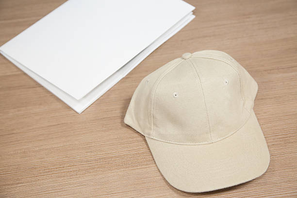 blank baseball cap and white folder stock photo