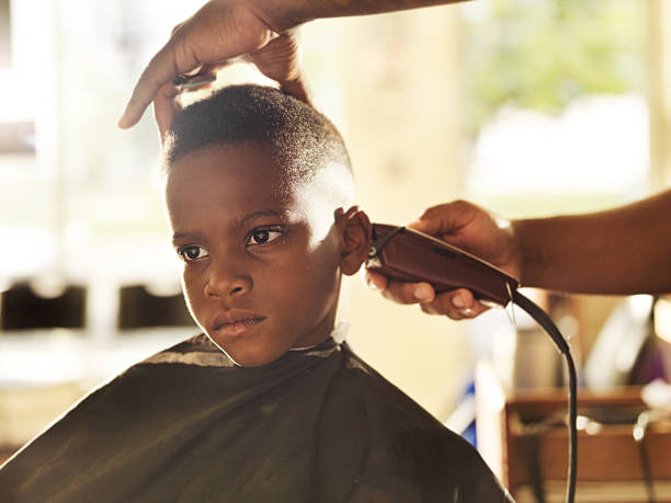 little boy getting his head shaved by barber - saç kesmek stok fotoğraflar ve resimler