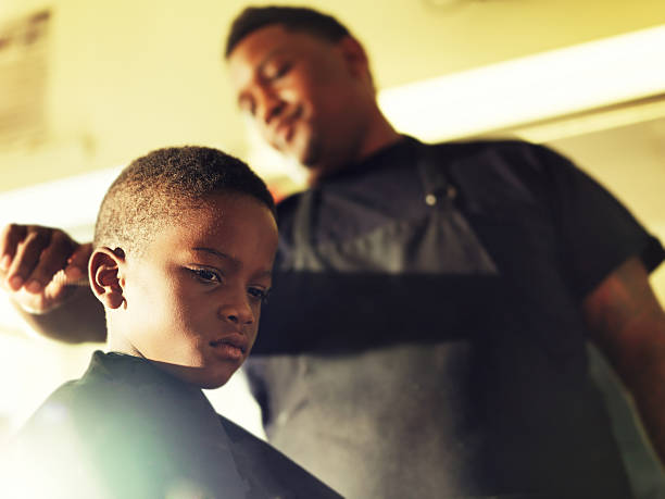 istock serious little boy in barber shop 464406046