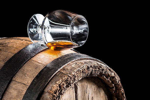 istock Old oak barrel and a glass of cognac 464406146