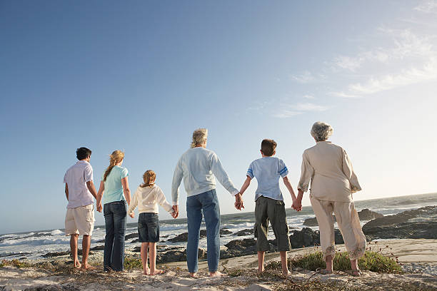 istock Three Generation Family Holding Hands On Seashore 464406164