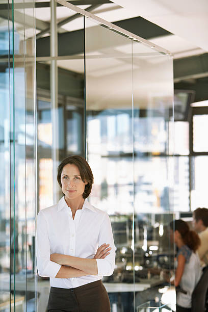istock Confident Businesswoman With Colleagues In Background 464406202