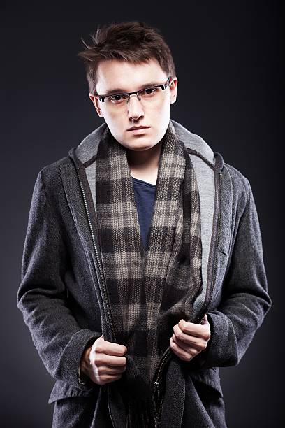 istock Elegant young man in coat and glasses 464406299