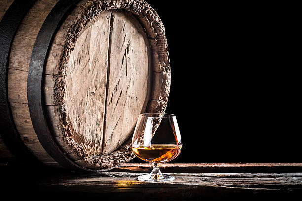 istock Old barrel and a glass of cognac 464406510