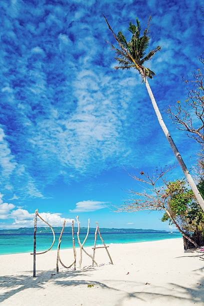 puka beach wooden sign in boracay island philippines