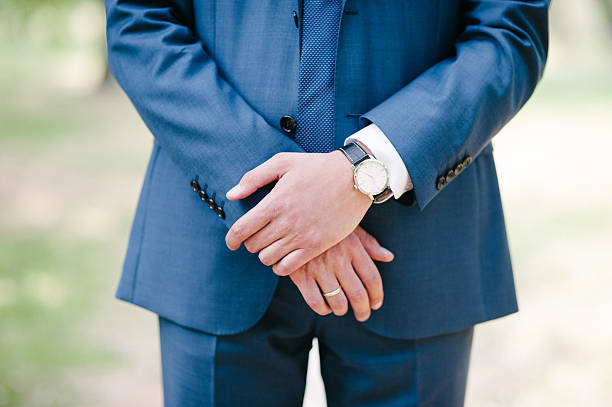istock hands of the bride with a clock and a ring 464410640
