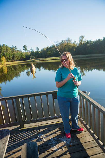istock Adult Woman Holding Caught Fish 464411388