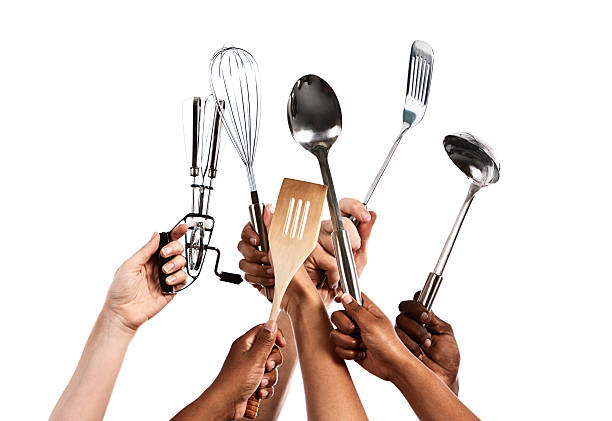 istock Six hands hold up varied utensils from well-stocked kitchen 464413381