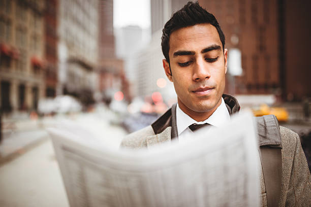istock business man reading a newspaper on manhattan 464415279