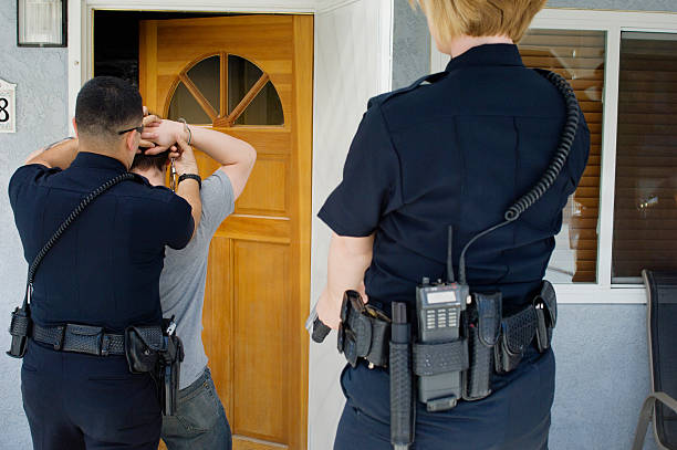istock Police Officers Arresting Young Man 464415902