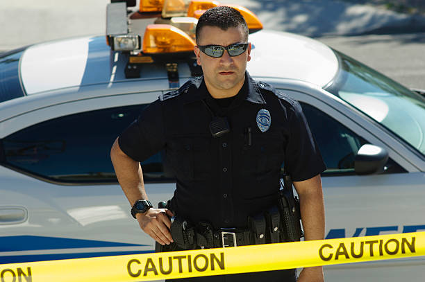 istock Caution Tape With Police Officer And Car 464415906