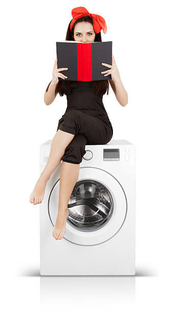 istock Girl Reading a Book on a Washing Machine 464416248