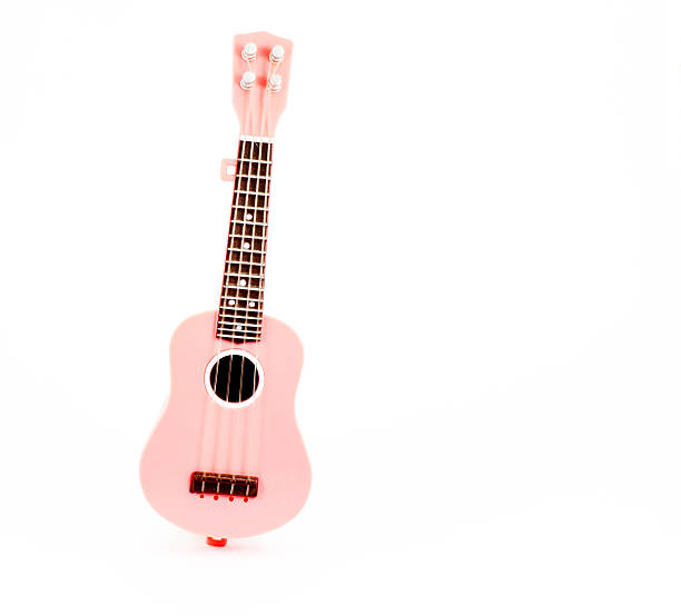 pink guitar toy isolated on white background