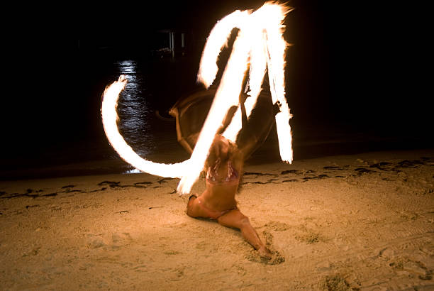 istock Beautiful woman spinning fire 464418121