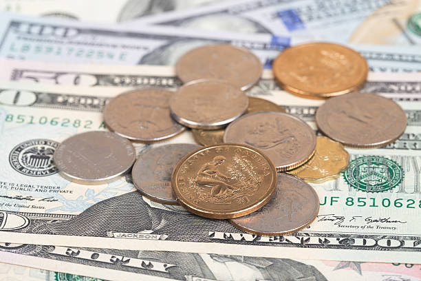 istock US coins on US banknotes close up 464420926