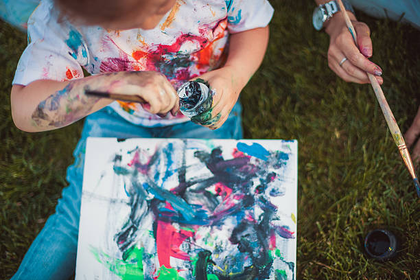 istock Mother and little daughter paint 464423732
