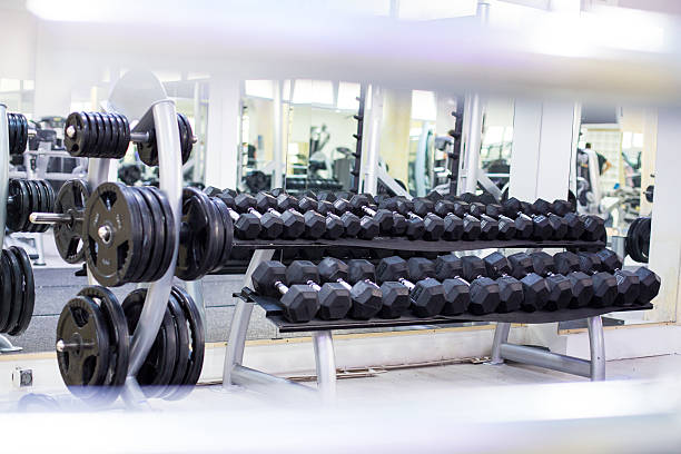 istock Black dumbbells in a row from a gym room 464423780