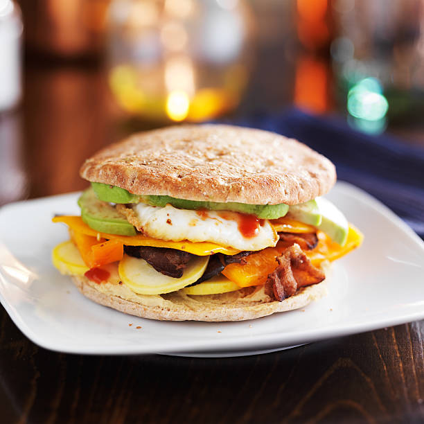 breakfast sandwich with egg, bacon and avocado