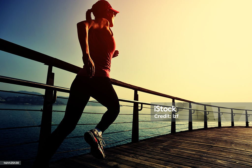 healthy lifestyle asian woman running at wooden boardwalk seaside healthy lifestyle asian woman running at sunrise seaside wooden boardwalk 2015 Stock Photo