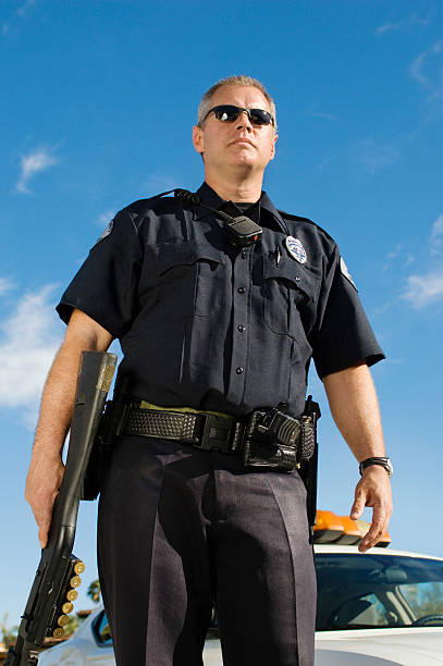 istock Police Officer with Shotgun 464425570
