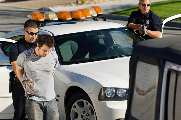 istock Police Officer Arresting Young Man 464425606