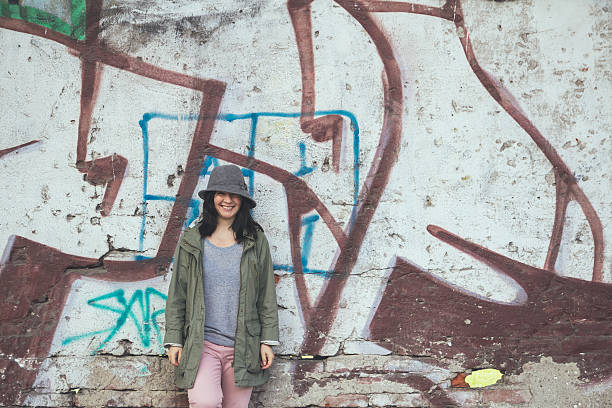 istock Smiling woman in front of wall 464425842