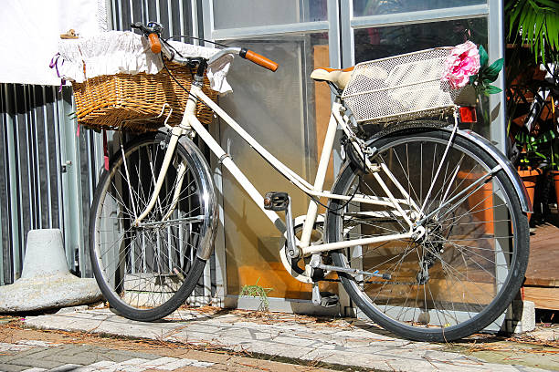 istock Bicycle with wicker basket stands near wall 464427240