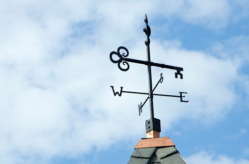 Top of church tower of protestant church with weather vane at rural Swiss town. Photo taken September 1st, 2022, Kyburg, Switzerland.