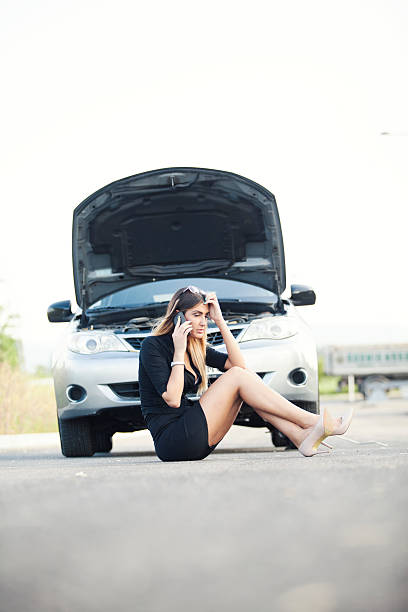 istock young woman with her broken car 464430100