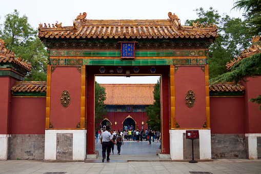 Beijing, Сhina - September 21, 2014:Entrance to the Yonghegong temple in Beijing with crowds of people in the background. This temple originally served as official residence for court eunuchs and was later converted into a Lamasery, or monastery for Tibetan monks, the other half served as an imperial palace. Work started on the temple in 1694 during the Qing Dynasty.