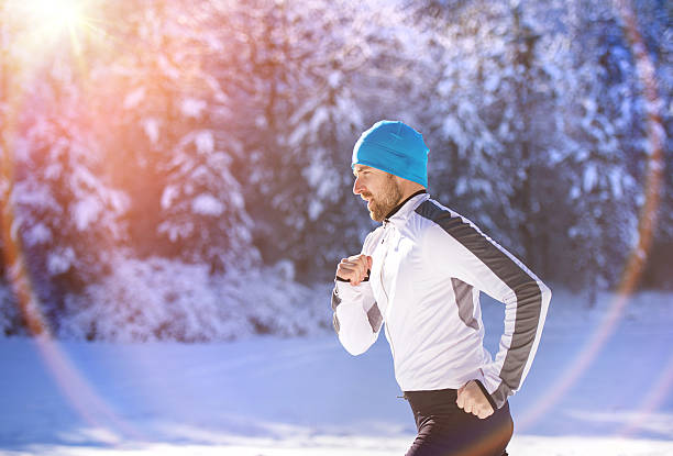 istock Man jogging in winter nature 464441118