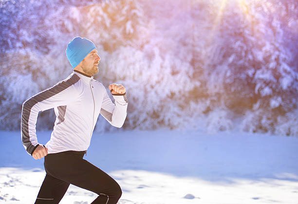 istock Man jogging in winter nature 464441128