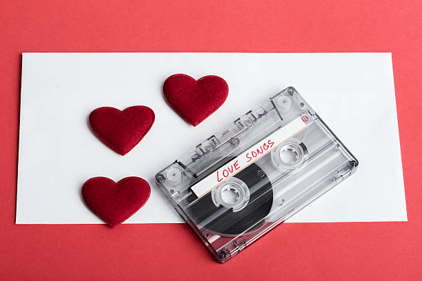 istock Audio cassette tape on red backgound with fabric heart 464441862
