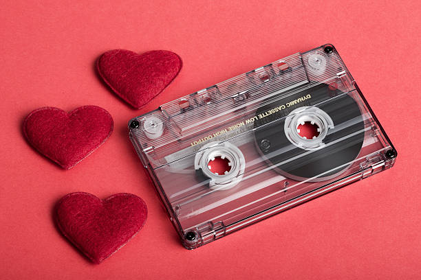 istock Audio cassette tape on red backgound with fabric heart 464441872
