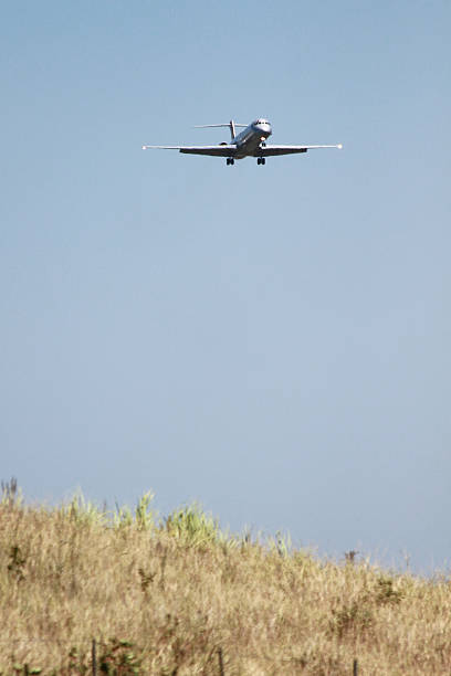 istock Plane coming in to land over a field 464442752
