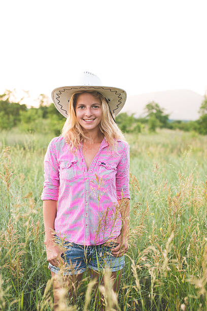 istock blonde cowgirl posing countryside 464446076