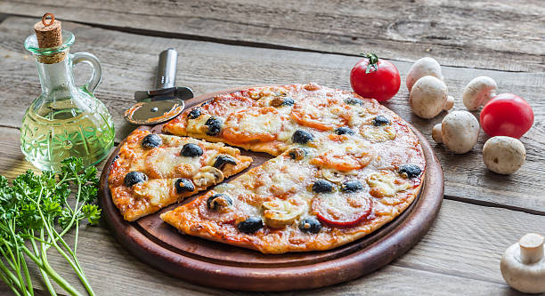 istock Cooked pizza on the wooden board 464447640